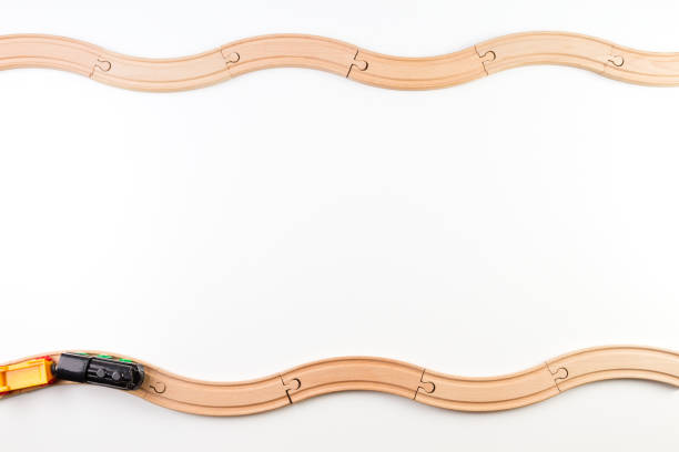 istock Toy train and curve wooden railways on white background. 914513286