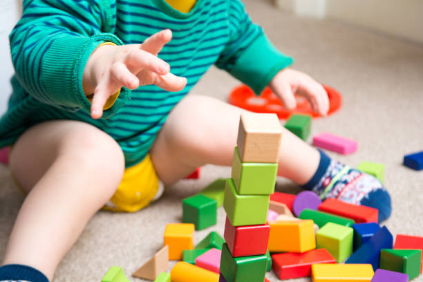 istock Baby playing with toy building blocks 914515564