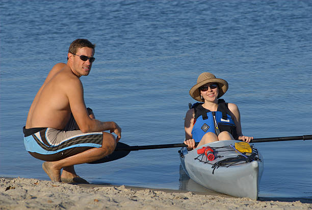 Attractive young female kayaker and her instructor stock photo