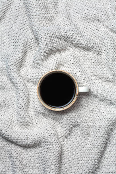 istock Coffee cup on wool background. Flat lay, top view. sweater knitted texture. 914517214