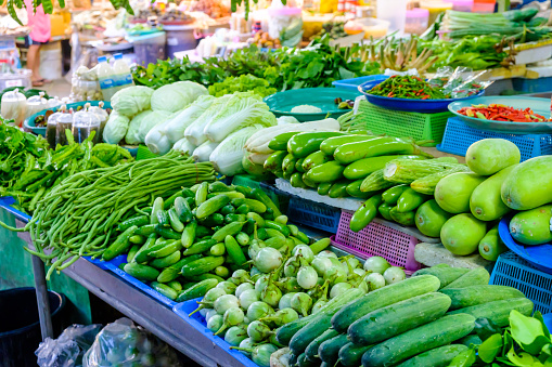 Asian farmer's market selling fresh green salat vegetables