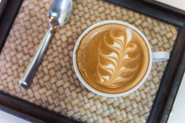 istock Hot cappuccino art with spoon on wooden plate, Top view 914520746