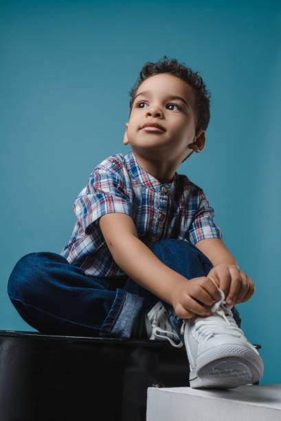 istock stylish and trendy boy in white sneakers 914524184