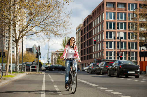 Woman cycling in Berlin downtown