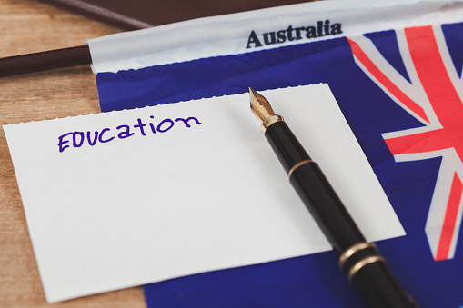 Education in Australia concept,passport and white note on Australia flag .