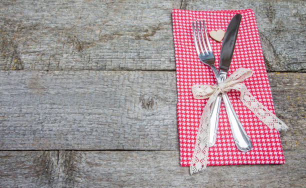 istock Valentine's Day. Romantic dinner. Fork and knife on wooden table 914530314