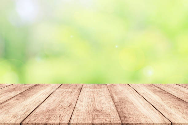 istock Wood table top on blur nature background with spring or summer 914533520