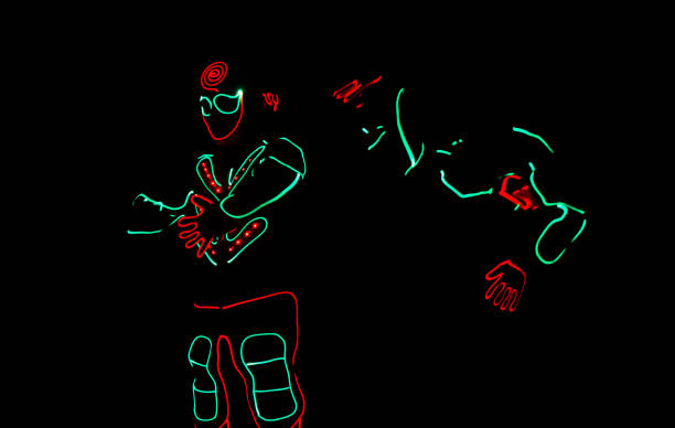 istock dancers in led suits on dark background, colored show 914533822