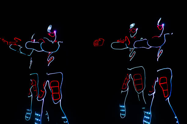 istock dancers in led suits on dark background, colored show 914533854
