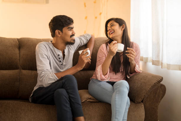 istock Cheerful young friends chatting on sofa 914533918