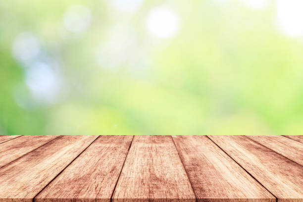 istock Wood table top on blur nature background with spring or summer 914535060