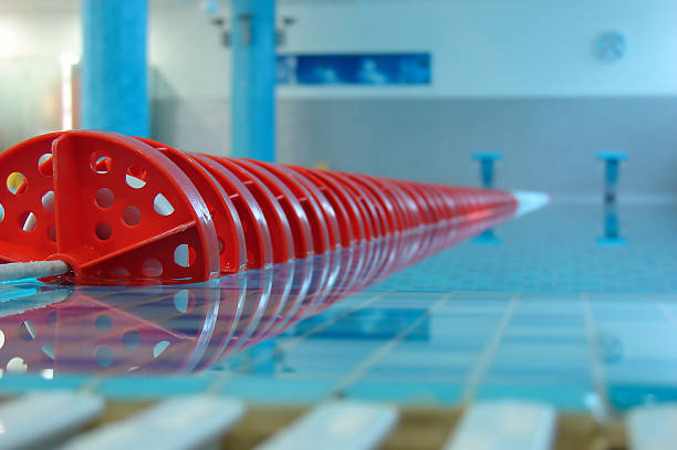 Close up of red swimming pool lane line stock photo