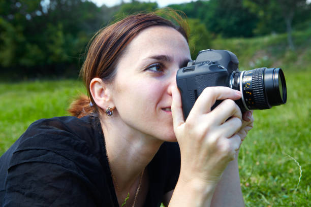 istock Woman photographer with camera 914538328
