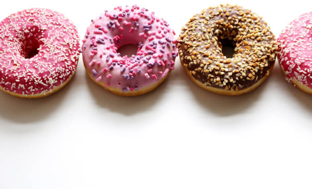 istock Glazed donuts on white wooden background. Top view 914538478