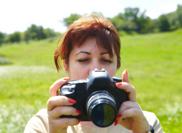 istock Woman photographer with camera 914538498