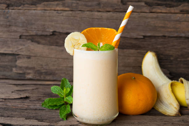 Orange and Banana smoothies Drink in the morning on  wood background.