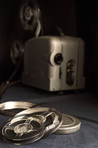 istock Old cinema projector and cassettes in the dark 914545568