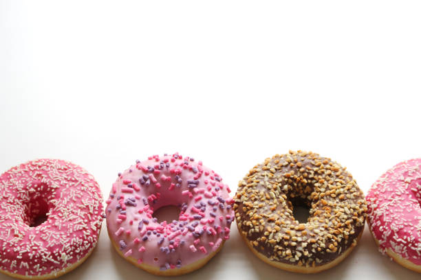 istock Glazed donuts on white wooden background. Top view 914545580