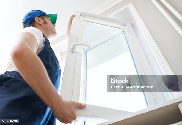 Professional Handyman Installing Window At Home Stock Photo - Download Image Now - Window, Installing, Replacement