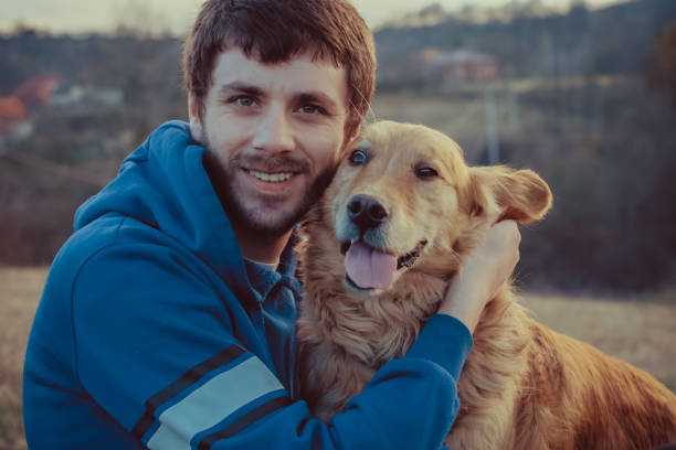 istock Guy and his dog, golden retriever, nature 914546028