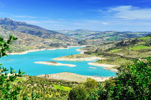 Beautiful scenery  with the turquoise colored Gastor Reservoir, surrounded by a rolling landscape with plantations.