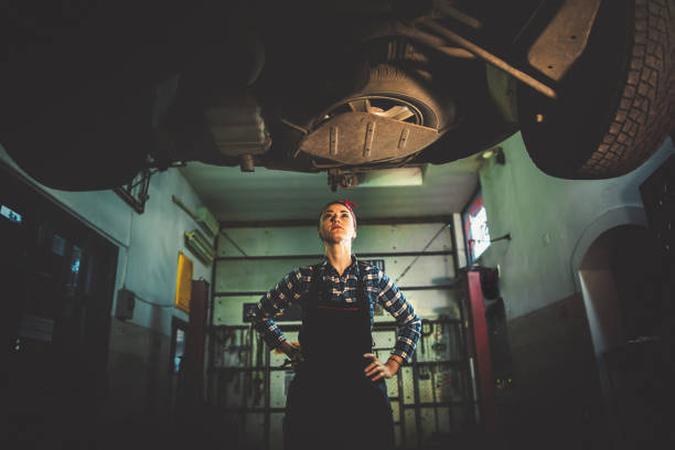 istock Young female mechanic repairing car 914549896