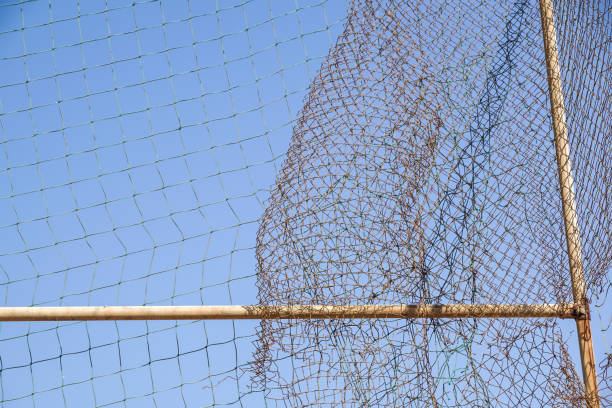 istock damage wire mesh steel on blue sky background 914551738
