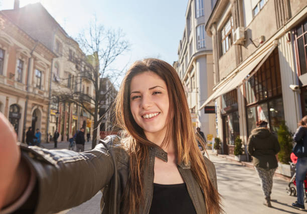 istock young girl make a selfy on the street in spring 914551752