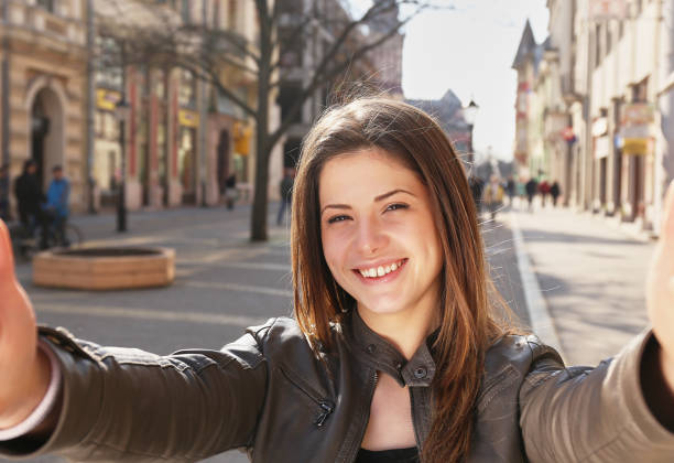 istock young girl make a selfy on the street in spring 914551984