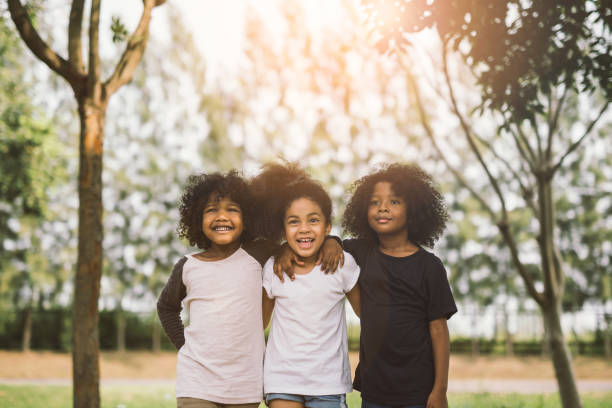 Children Friendship Children Friendship Togetherness Smiling Happiness Concept.Cute african american little boy and girl hug each other in summer sunny day children only stock pictures, royalty-free photos & images