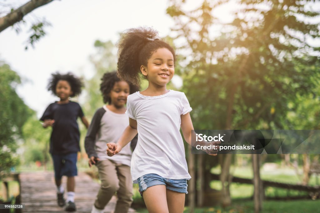 little girl playing outdoor Cute african american little girl playing outdoor - Black people kid and friend happy. Child Stock Photo