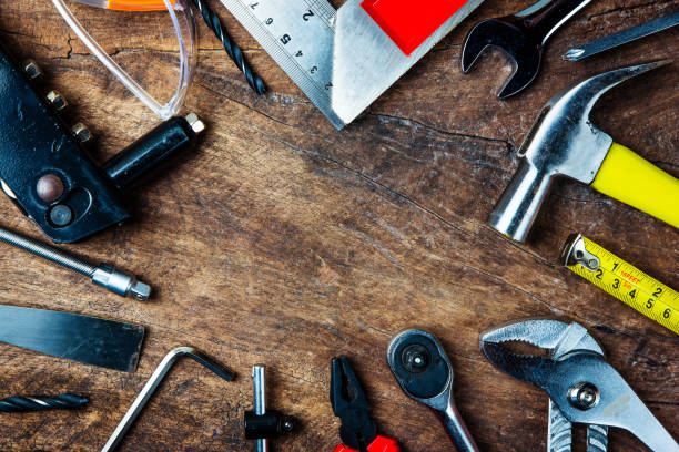 istock Set of construction tools on wooden board as wrench, hammer, pliers, socket wrench, spanner, tape measure, electric drill,safety glasses, screwdriver. 914552604