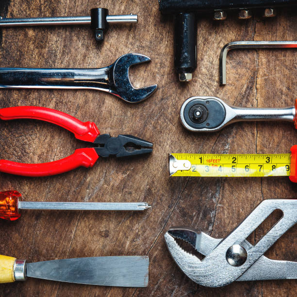istock Set of construction tools on wooden board as wrench, hammer, pliers, socket wrench, spanner, tape measure, electric drill,safety glasses, screwdriver. 914552632
