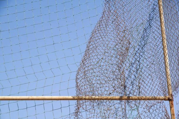 istock damage wire mesh steel on blue sky background 914552640