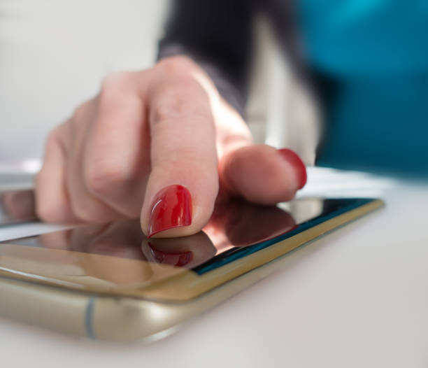 istock Extreme close up older woman using internet on hergold smartphone 914555150