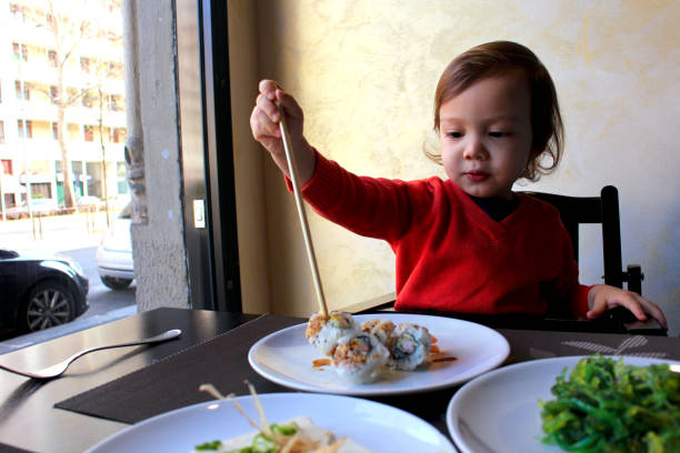 istock Toddler eat sushi 914558814