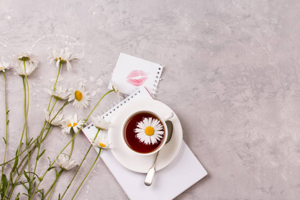 istock cup of tea with chamomile flowers on grey stone background 914559490
