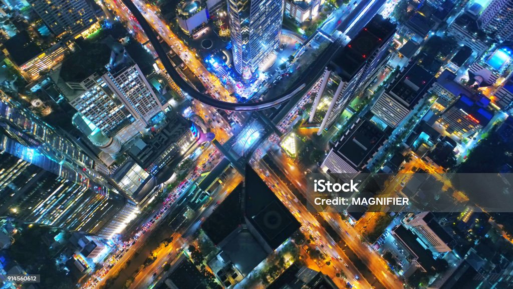Aerial view Road roundabout, Expressway with car lots in the city in Thailand. Top view of traffic on freeway. Beautiful street background at downtown Bangkok. City Stock Photo