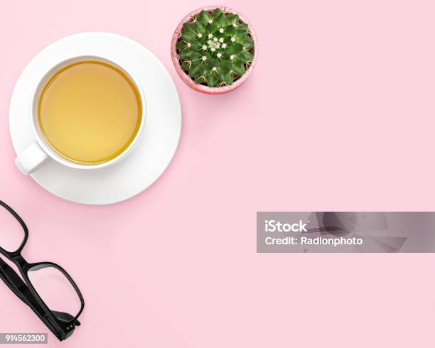 Flat Lay Photo Of Office Desk With Tea Mug Cactus Glasses Pink Background Stock Photo - Download Image Now