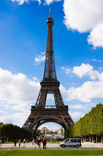 Paris, France - June 29, 2013: Parisian Street against Eiffel Tower on 29 June 2013 in Paris, France. The tower is the tallest structure in Paris and the most-visited paid monument in the world.