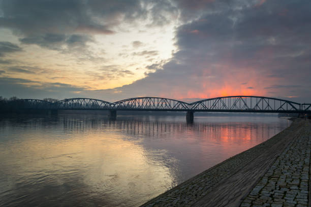 istock Bridge on the Vistula River lit by the setting sun. 914564292