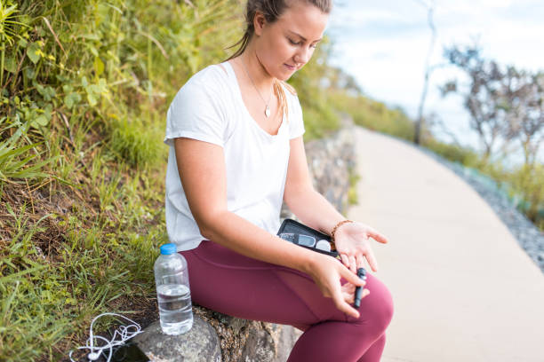 Woman measuring glucose after workout Woman measuring glucose after workout diabetes and exercise stock pictures, royalty-free photos & images