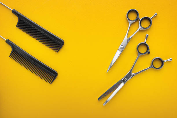 istock Scissors and hairbrush isolated on yellow 914579486