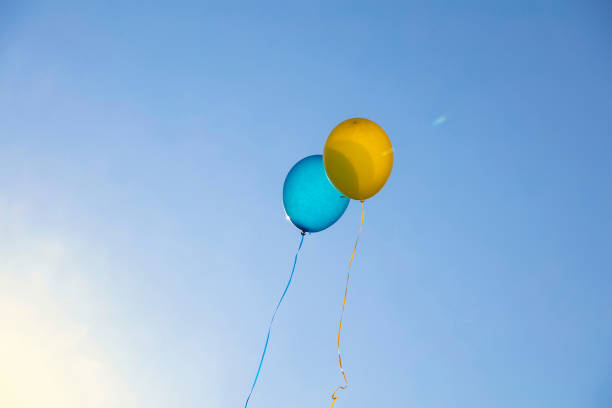 istock Low Angle View Of Balloons Flying Against Blue Sky 914583744