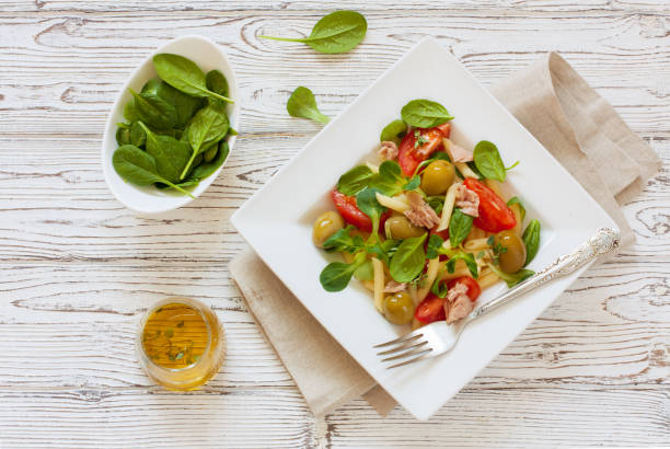 istock Salad with pasta, lettuce, tuna and green olives 914588704
