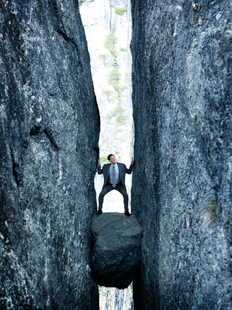 istock Businessman Between A Rock And A Hard Place 914593410