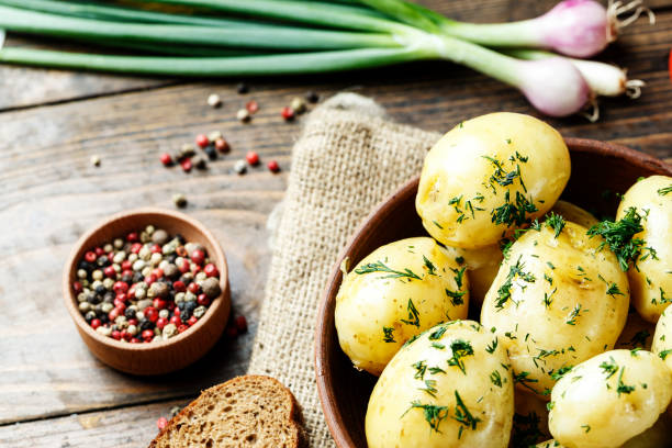 istock Summer dinner set with potatoes, summer vegetables, with young onions and tomatoes. 914593744