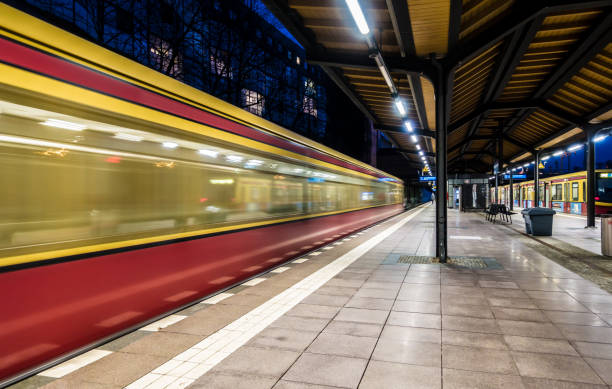 istock Blurred Motion Of Train At Railroad Station During Night 914593984