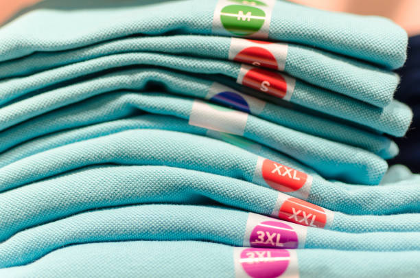 Different T-shirts size  on a shelf in a boutique
