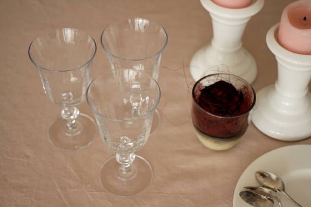 istock Romantic table with candles, red rose, plate, empty wine glasses and cutlery 914594210